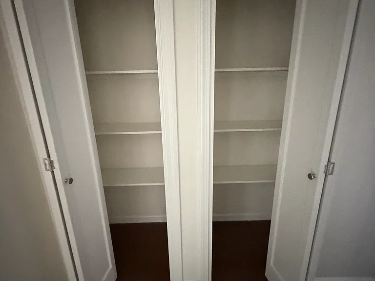 Hallway closets with shelving