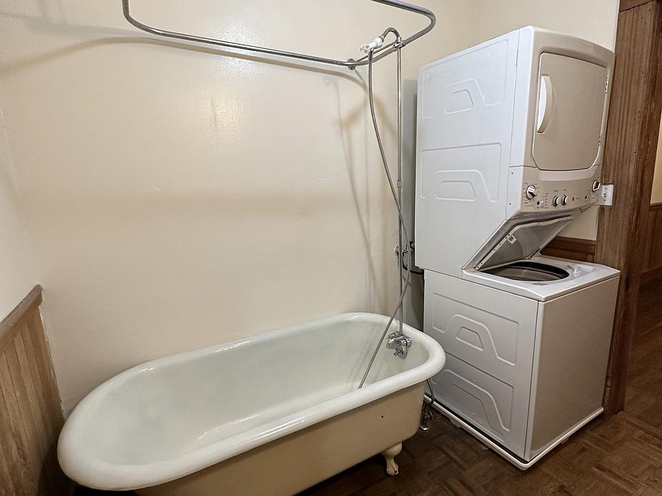Clawfoot bathtub with shower and washer/dryer