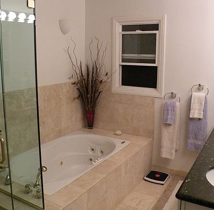 master bath w/ jacuzzi tub, granite countertops and travertine