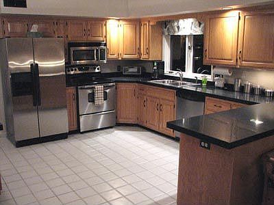 updated kitchen with granite countertops and stainless steel appliances
