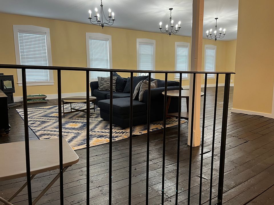 Living Room Pic 1(walking up the stairwell from the wash room up to the main living space. Pellet stove is the main source of heating and is in the corner of the room)