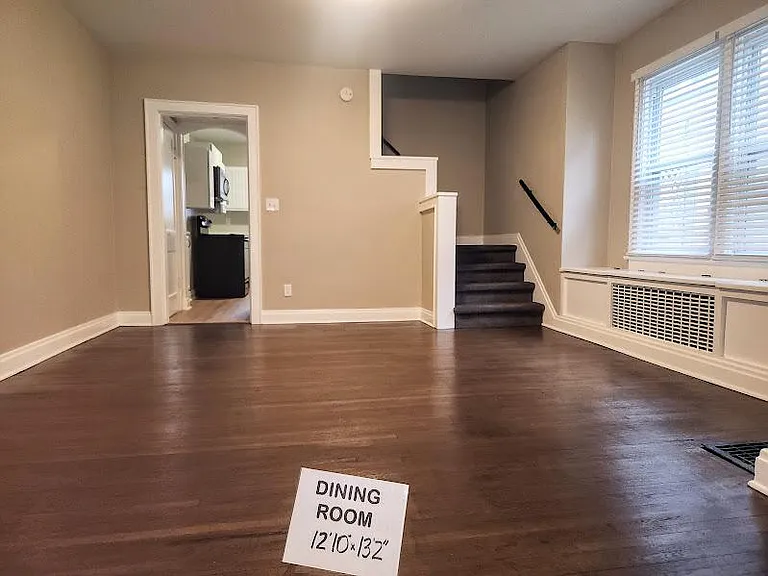 Spacious Dining Room 12'10" x 13'2", newly refinished hardwood floor, built-in storage, large windows with new wide blinds, new carpet on stairs