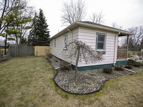 View of front east side of home shows the maintenance free landscaping continues all the way around 