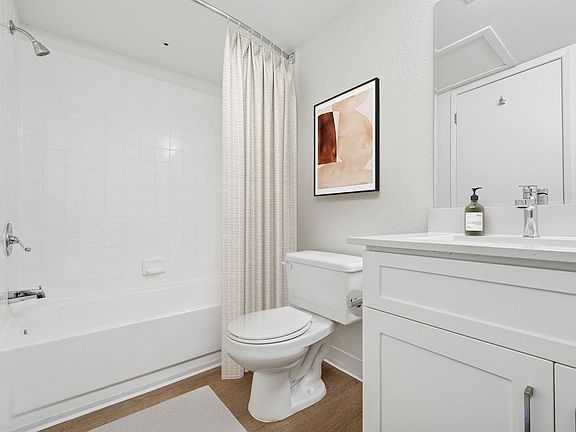 Upgraded Collection bath with white cabinetry, quartz countertop, and hard surface flooring