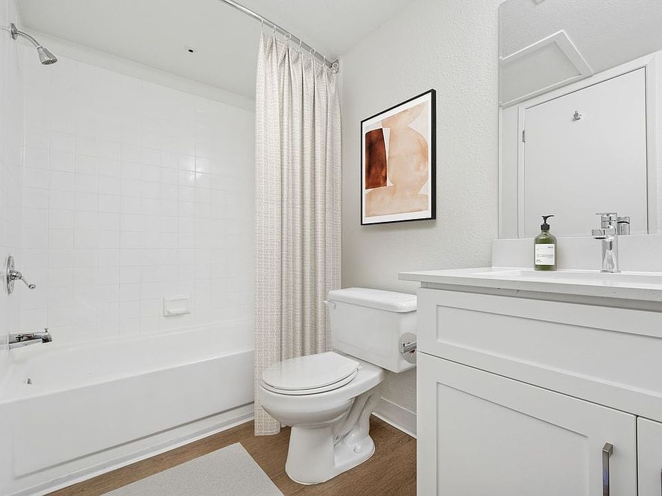 Upgraded Collection bath with white cabinetry, quartz countertop, and hard surface flooring