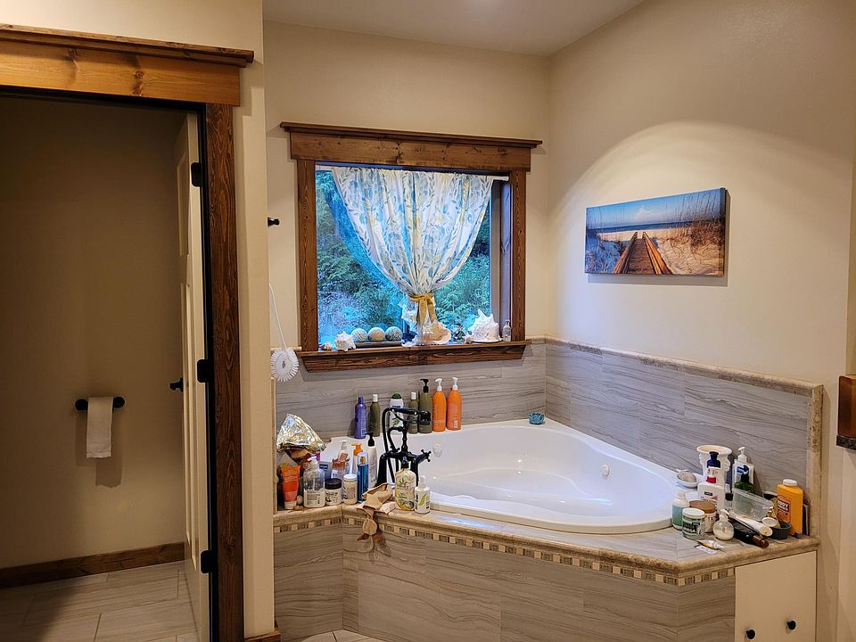 Jetted tub-private comode separate tiled shower.