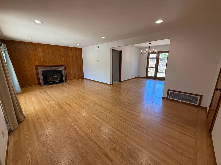 Bright, airy living room features bay window, hardwood flooring throughout and a patio door that flows to a relaxing backyard.