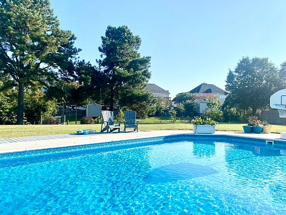 Large pine trees provide lots of privacy, and the pool brings the tranquility right off your backdoor.
