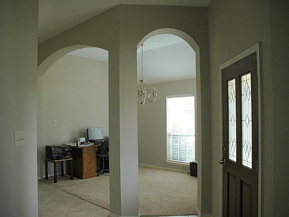 Front Entry looking into the Formal Dining Room. Arched doorways and high ceilings throughout.