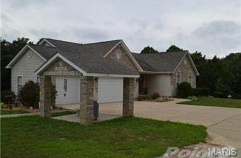 Paved path leads from front to backyard