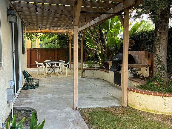 Back yard with shaded patio and built in barbecue