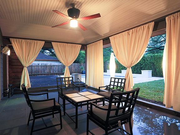 An amazing entertainment space, the lovely covered back patio with ceiling fan, and additional space