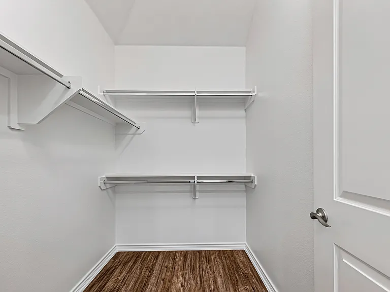 Large primary walk-in closet with ample storage space.
