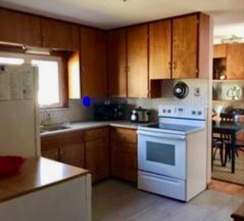 Kitchen with quartz counters and ceramic tile floor.