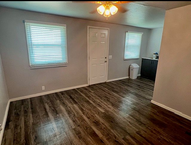 View from living room looking towards the from door and into kitchen.