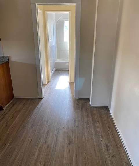 Hall leading to kitchen, bathroom, and bedrooms.