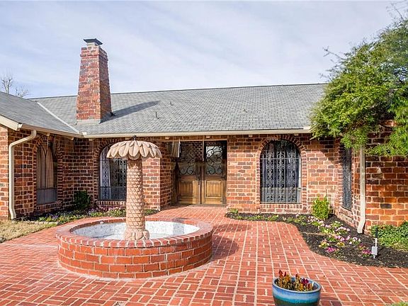 The pretty front courtyard has a great fountain. Enter the home through massive wood double doors. Just imagine this summer a courtyard full of plants with the sound of the fountain in the evening.