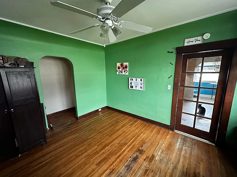 The formal dining room opens up to the bathroom and two bedrooms off the hall. The original swinging door leads to the updated kitchen, backyard, and private large master bedroom.