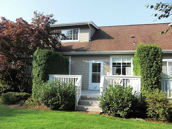 Back of condo features a nice deck to relax on. Dues include all exterior maintenance and lawn care.