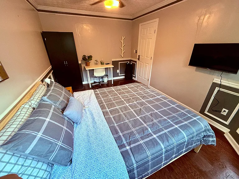 Queen-size bed and workspace a