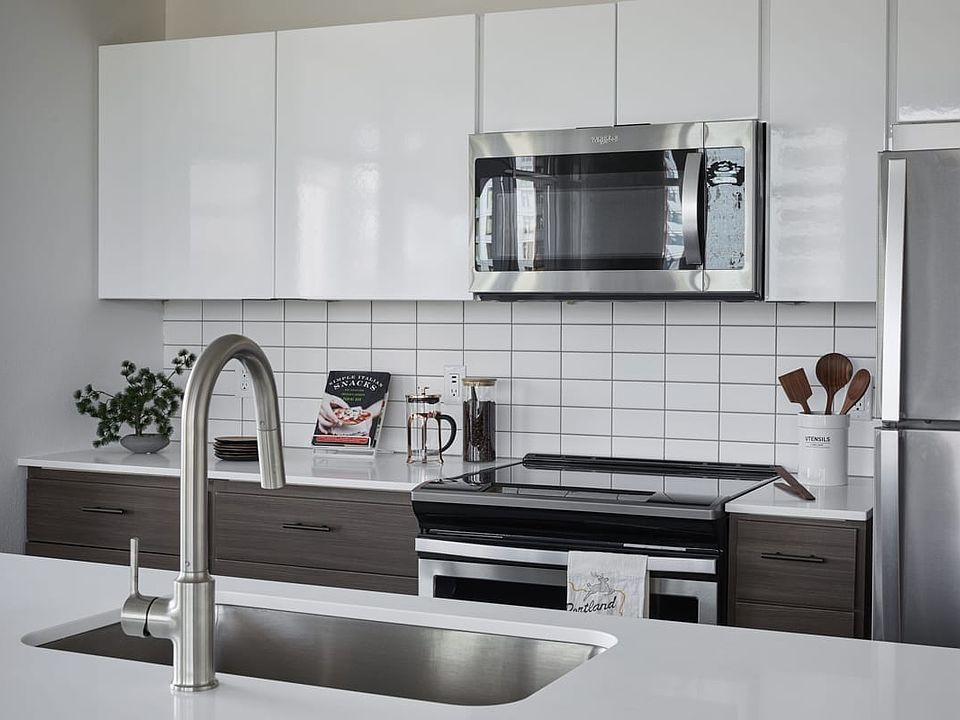 Large kitchen with island and stainless steel appliances