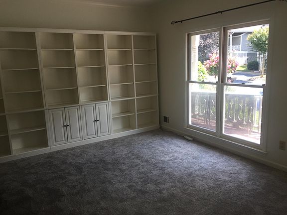 Two windows in the living room overlook the front porch.