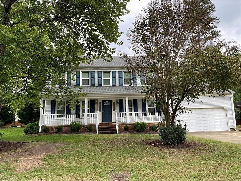 Front of this lovely home featuring shades trees 