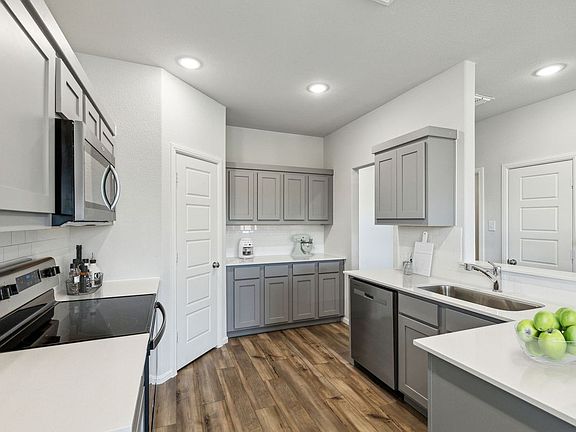 Kitchen in the Sapphire home plan by Trophy Signature Homes - REPRESENTATIVE PHOTO