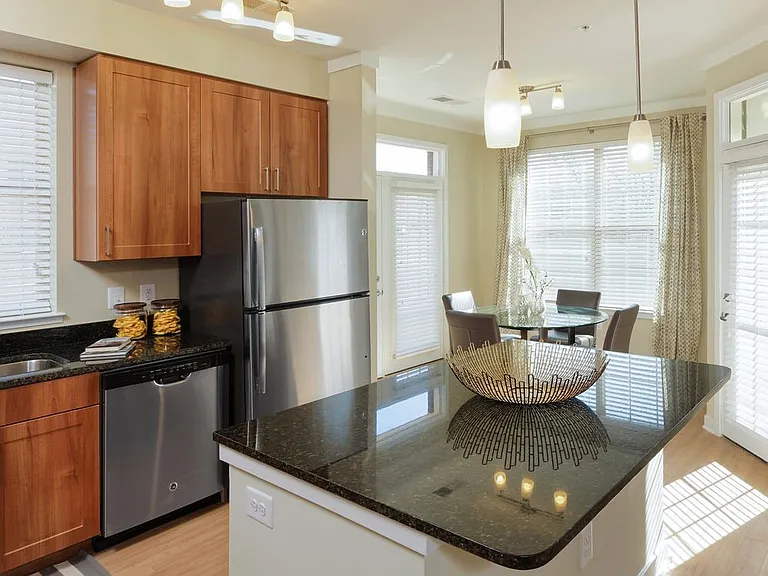 Classic Package I kitchen with stainless steel appliances, oak cabinetry, black granite countertops, and hard surface flooring
