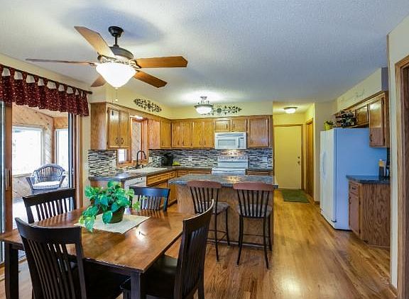 Open floor plan with adjoining kitchen, family room, four season porch and living room!
