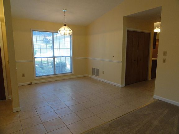 Formal dining room area connected to great room. Hall way on right leads to kitchen area.