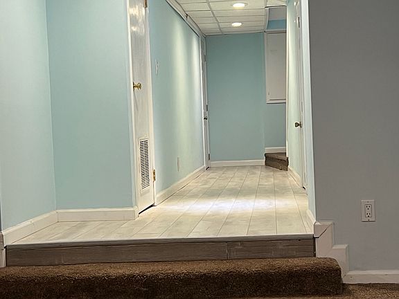 Step down to large carpeted living area with tons of room. all the way down the hallway to the left is the separate bedroom.
