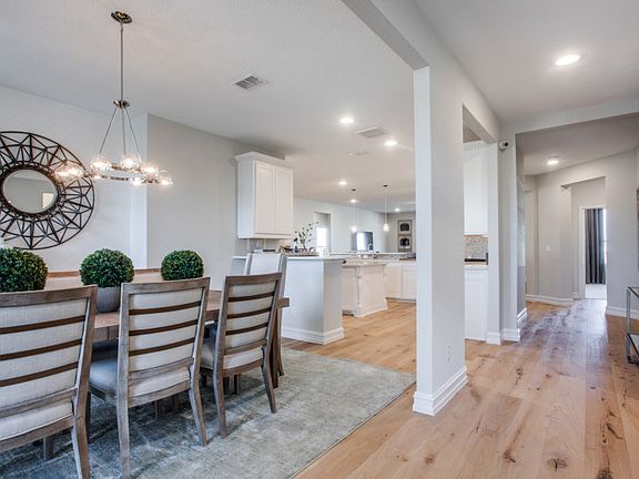 Foyer overlooks formal dining and into kitchen model representation