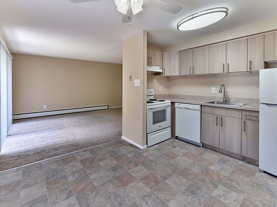 Updated kitchen with wood-style cabinets and open-concept design at Maple Terrace Apartments in Maple Shade, NJ