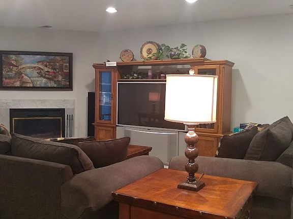 Huge family room with fireplace and entertainment center and TV