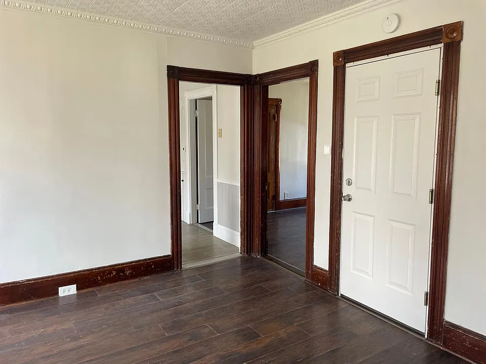 dining room (looking toward entryway door, bedroom door, and kitchen)