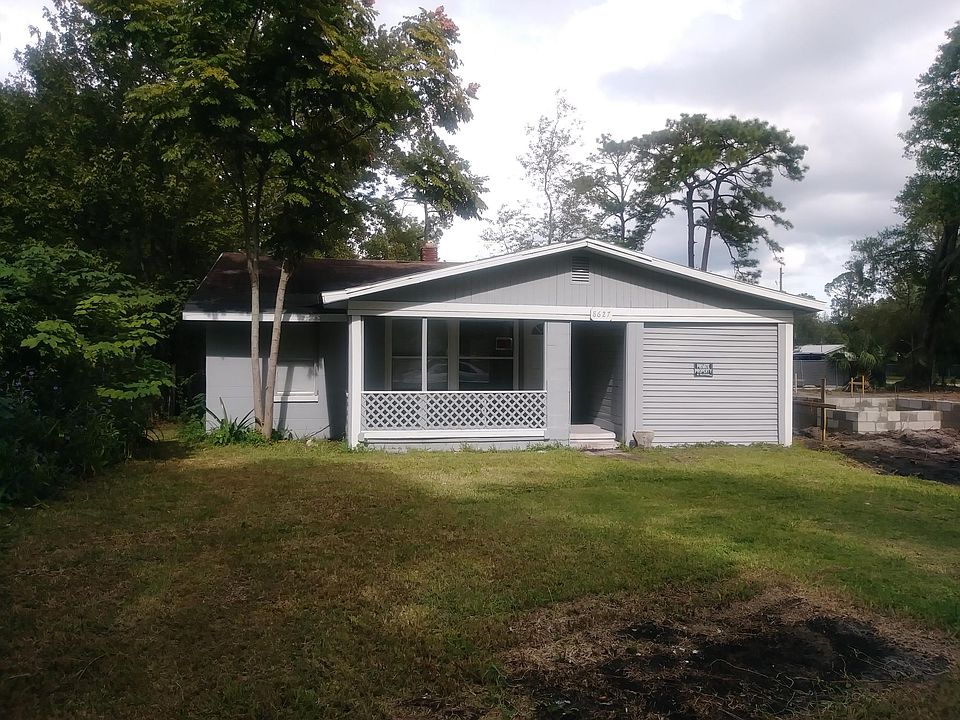 Front of home with yard and porch.