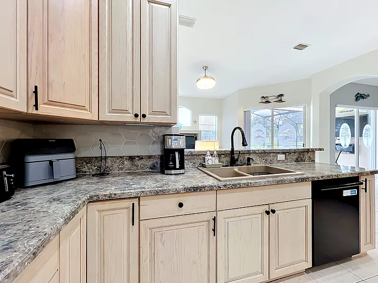 Kitchen overlooking family and pool area