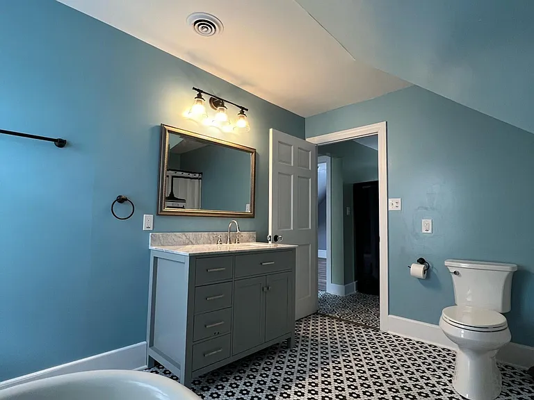 Large bathroom with bathtub and large shower stall.