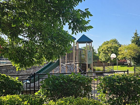 Neighborhood park maintained by HOA has multiple zones for kids of all ages