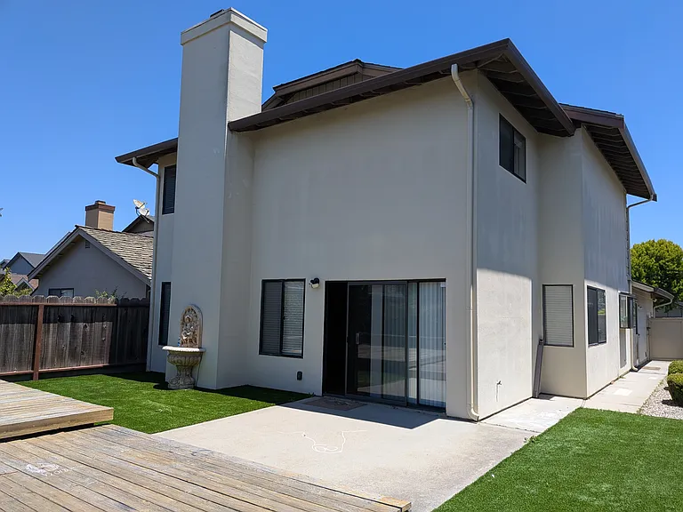 View of the backyard and glass sliding door to the living room