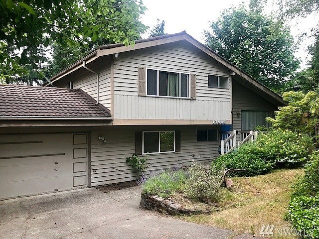 Welcome home to Fairwood Greens! This tri-level home has 3 bedrooms, 3 bathrooms, and a ton of potential! The living room features a large picture window and vaulted ceilings that extend to the kitchen and informal dining area. The kitchen and dining area overlook the large backyard and swimming pool, plus a peek a boo view of the spacious family room with a wood burning fireplace below. In the kitchen you'll also love the black granite counters, sunny garden window and extra pantry storage. Upstairs you'll appreciate the master bedroom with ensuite bath plus two additional bedrooms and a full bathroom. A sunroom addition was made off the kitchen which houses a hot tub. Outside you'll enjoy extending your gathering to the entertainment sized patio. This home has great bones but is in need of TLC to make it shine again--opportunity awaits!