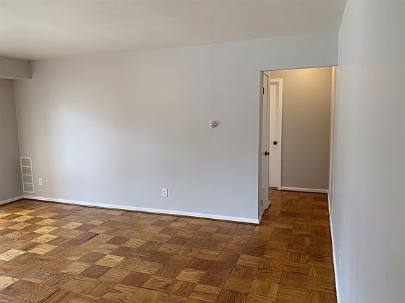 Living area and hallway to bedroom. New paint in modern grey color. New doors and hardware.