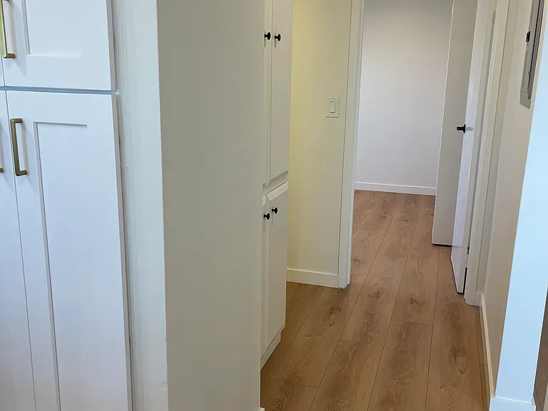 View from kitchen to larger bedroom.