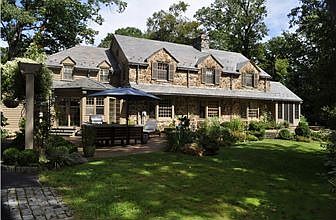 Rear view of home with large terrace and gardens