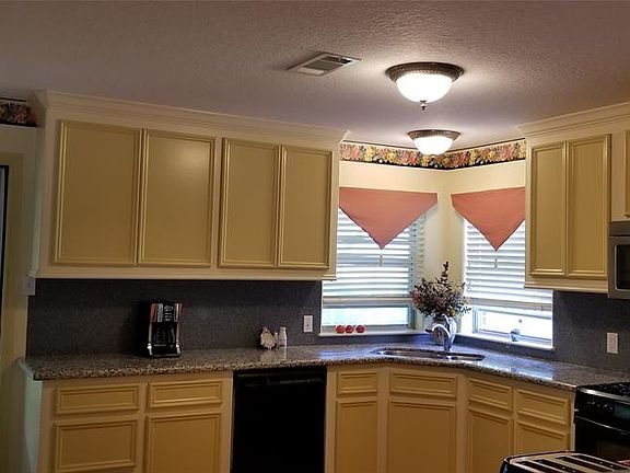 Granite counters line the spacious and plentiful cabinets in the great country kitchen. All appliances except refrigerator remain