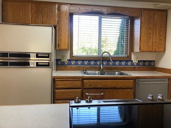 Kitchen shot through the pass - through bar / counter open to Living room