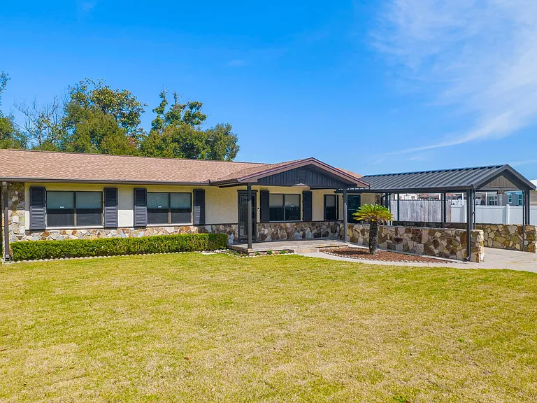 Fully remodeled home, inside and out. Ample parking, including a parking pad for a small boat or jet skis behind the gate to the right of the carport.
