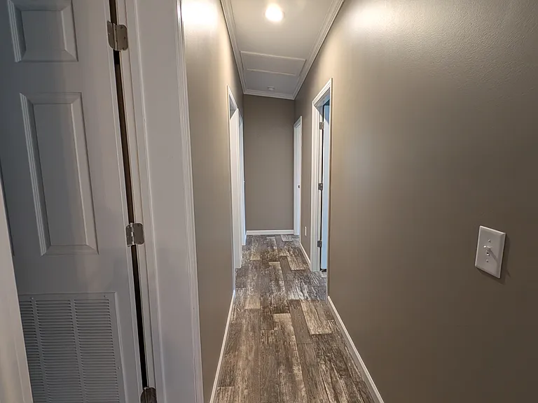Hallway to laundry room, common bath and 3 bedrooms with master bath in master bedroom