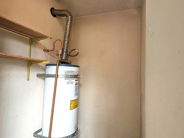 Storage with water heater outside of unit